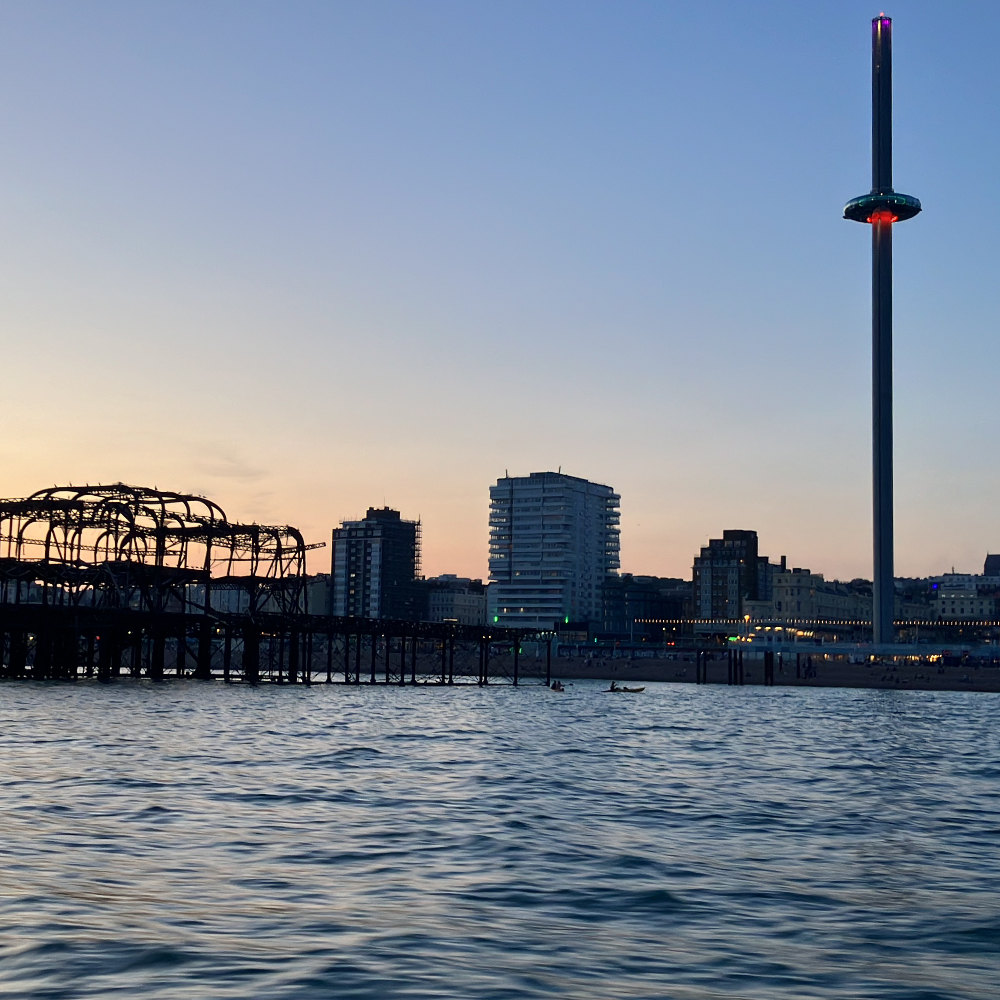 image shows the burned down Brighton west pier and the I360