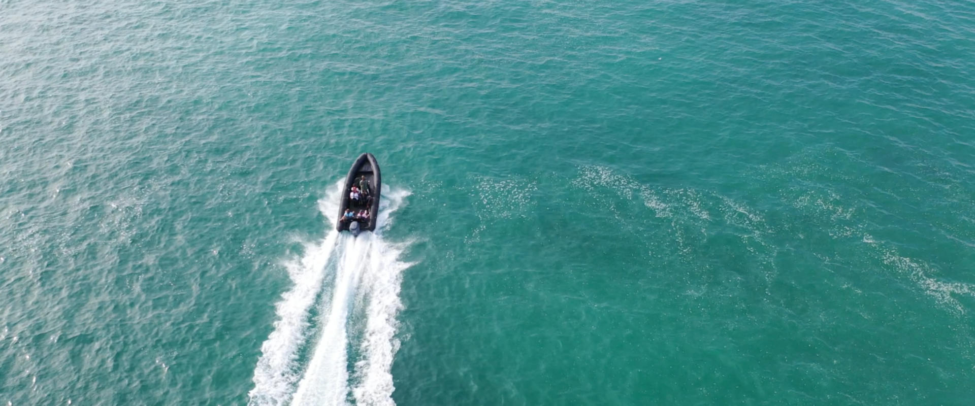 ariel shot of the powerboat surrounded by the sea 