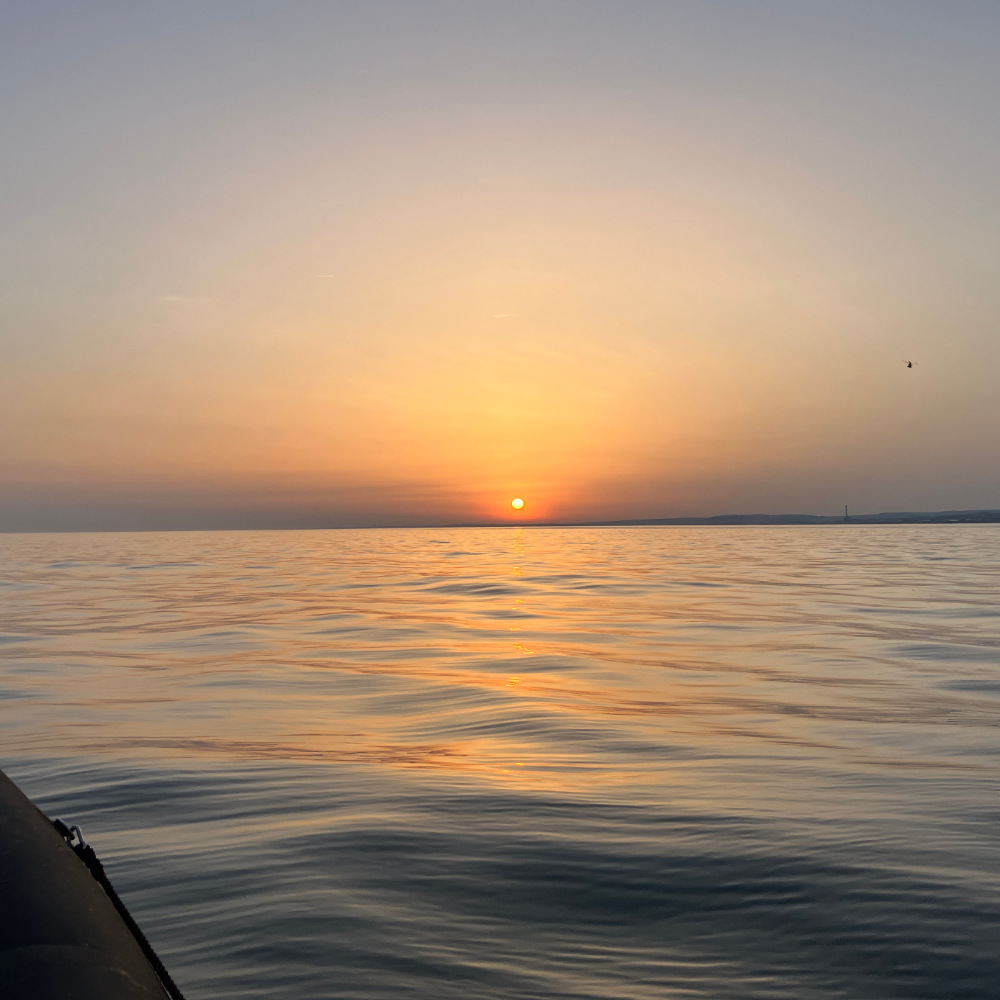 image shows the sunset over the sea