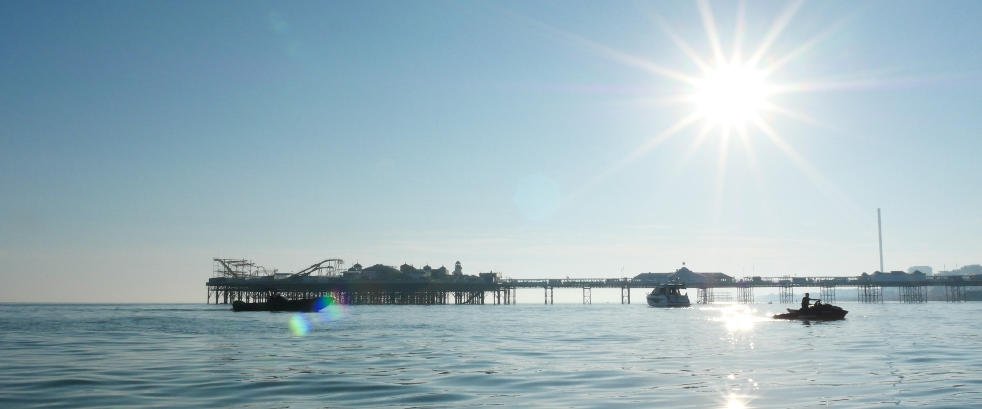 image shows the Brighton Palace Pier taken from along side with a jet Ski