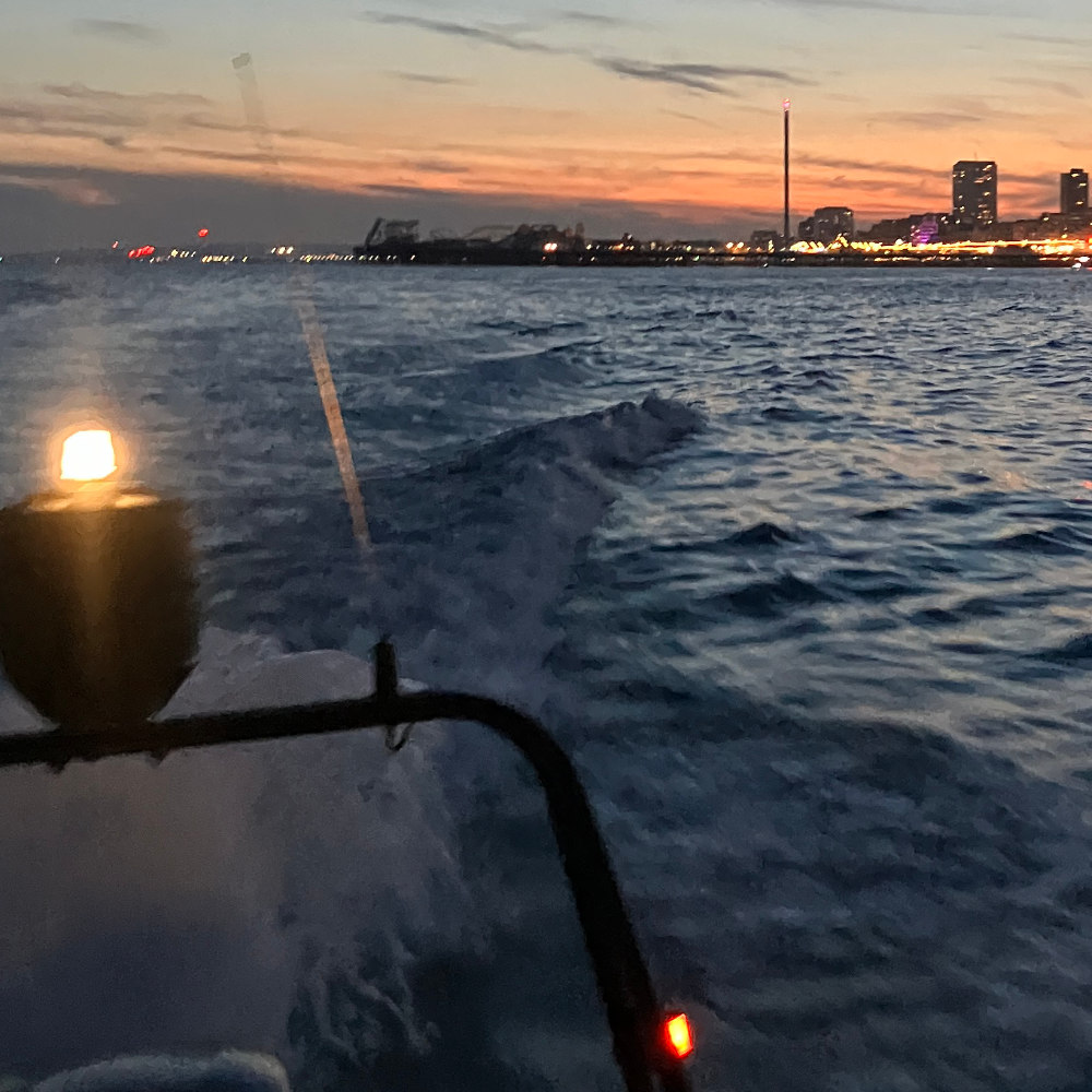 image shows the wake of the boat and the sunset